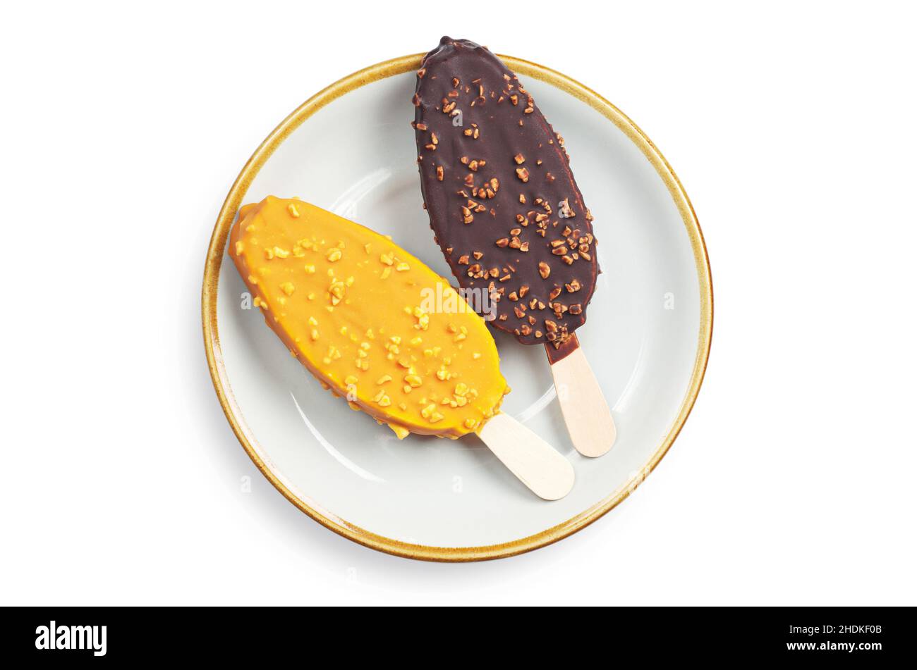 Two ice cream in caramel and chocolate glaze in plate on white background, top view Stock Photo