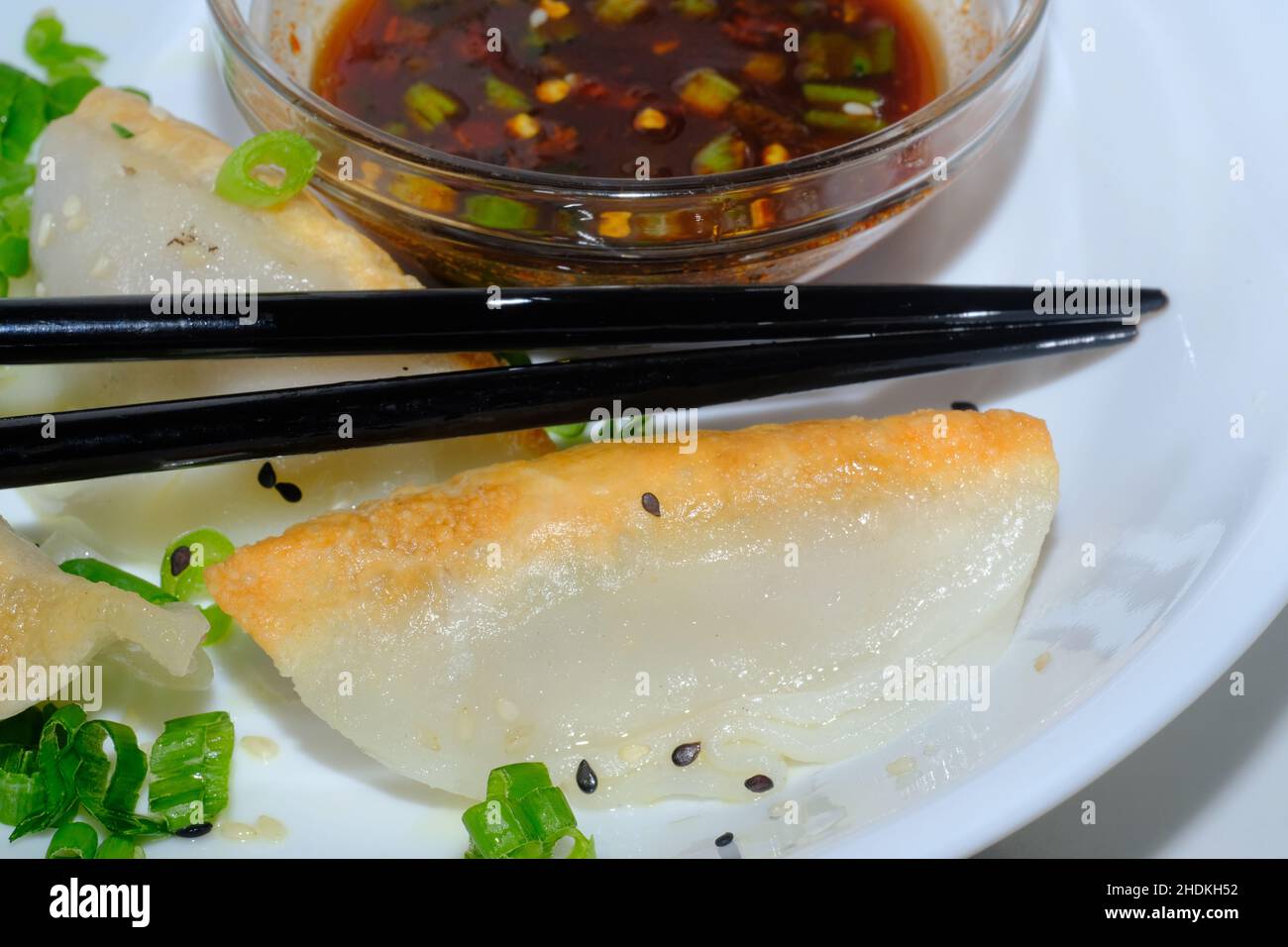 Homemade fried Asian potsticker dumpling appetizer with spicy ponzu dipping sauce Stock Photo