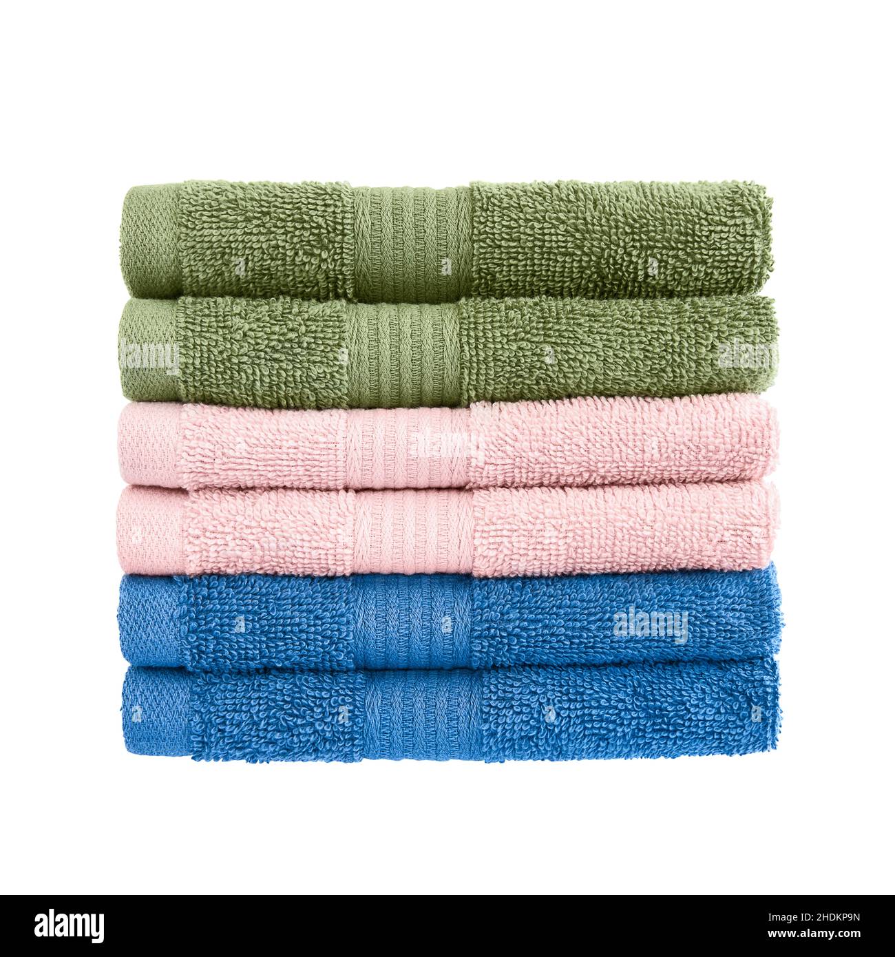 Green, pink and blue bath towels in stack isolated over white background with clipping path. Stock Photo