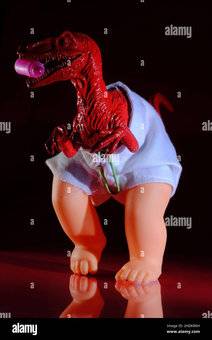 Raptor baby in diaper as metaphor concept for the difficulties of parenting and dealing with young children Stock Photo