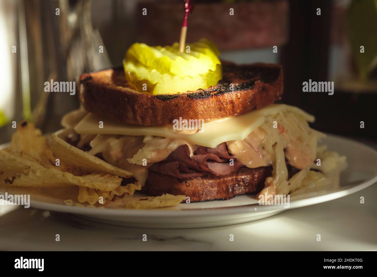 Roast beef and swiss cheese sandwich with cole slaw and dill pickle