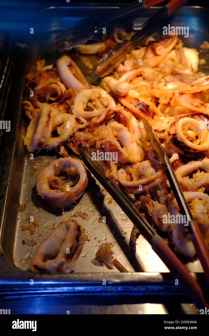 Calamari all you can eat buffet tray with rings and tentacles Stock Photo