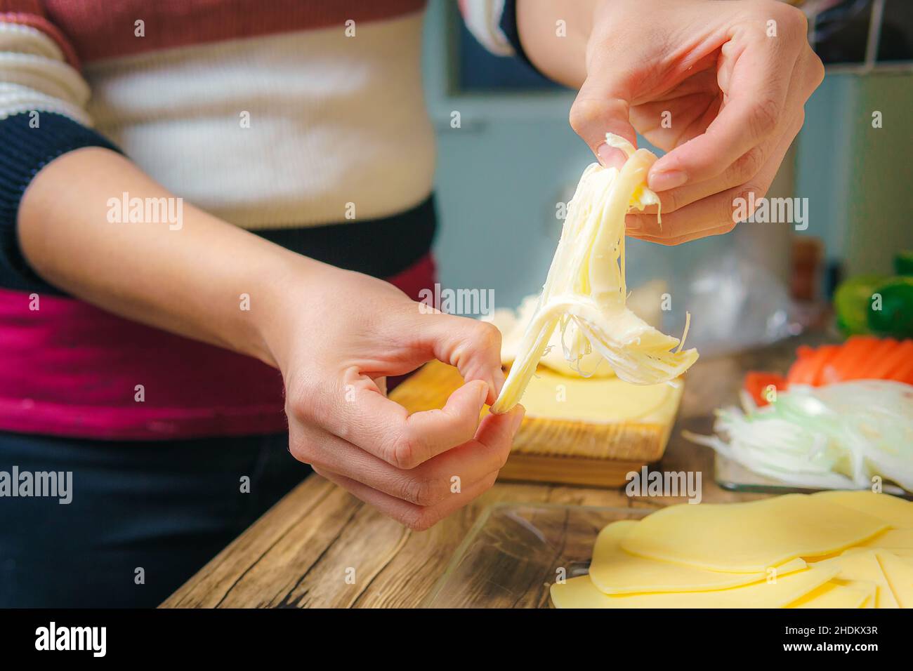 Hands using a cheese grater Stock Photo - Alamy