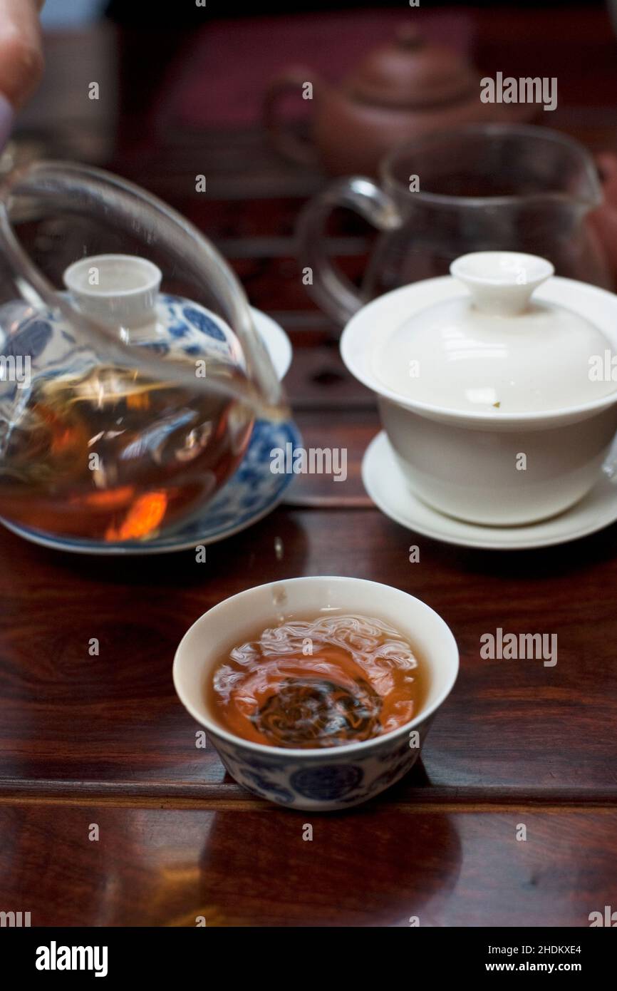 Pouring cups of young Yunnanese Puehr tea, Hong Kong. Stock Photo