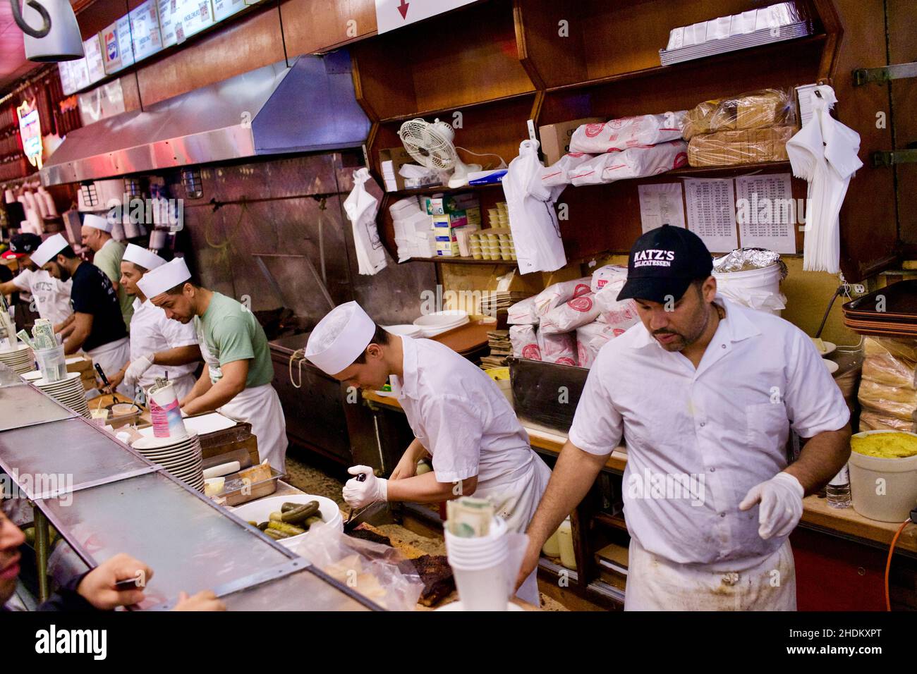 Workers behind counter at World famous Katz's Deli, located on the