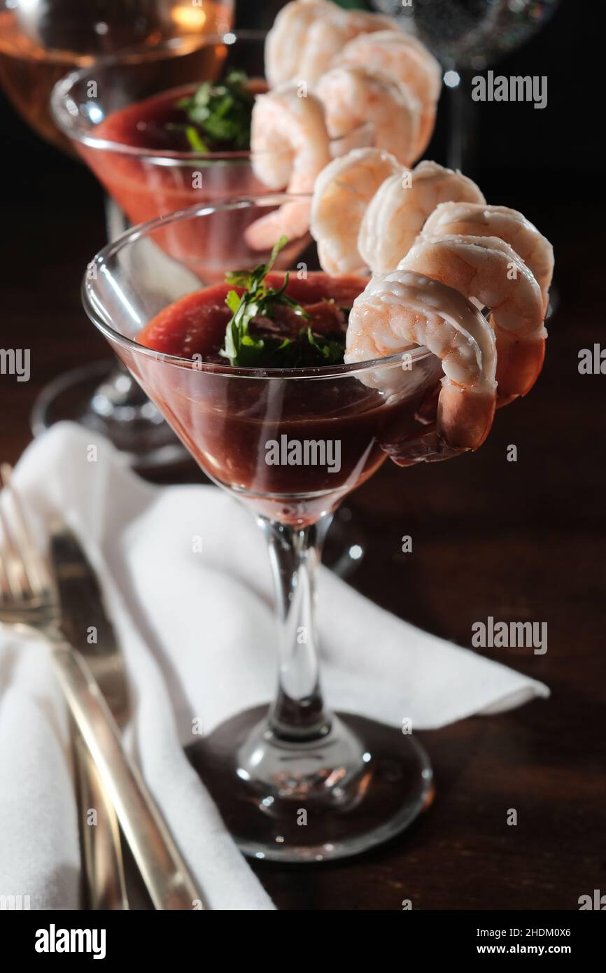 Delightful tail-on shrimp cocktail served with horseradish dipping sauce in martini glass Stock Photo