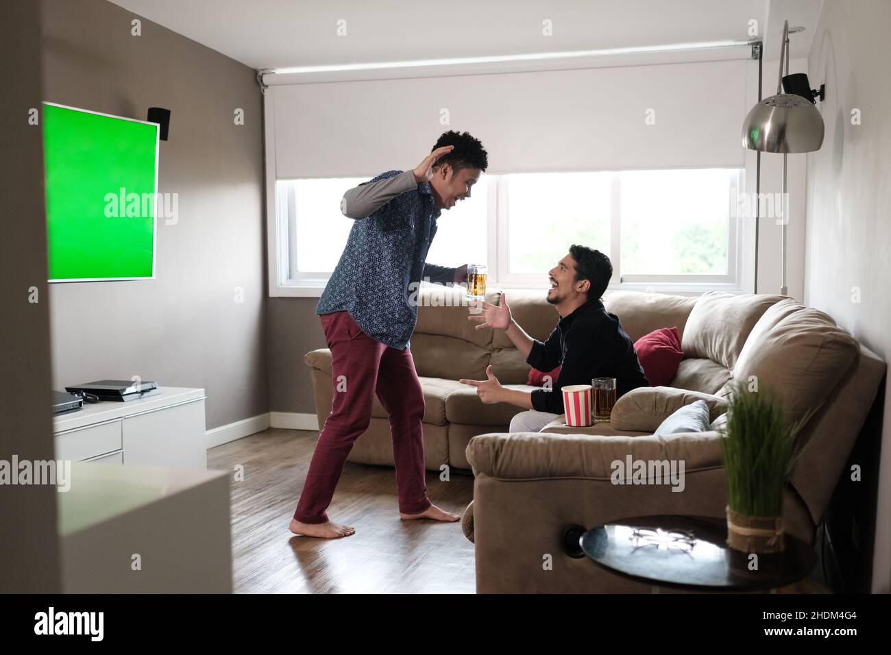 watching tv, toast, high five, television, tv, toasts, high fives Stock