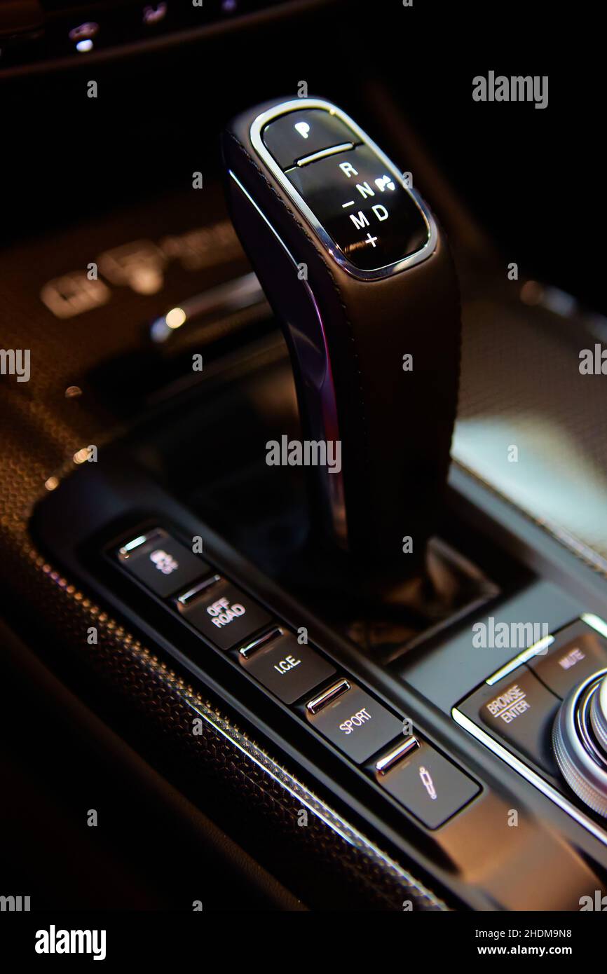 Automatic gear stick of a modern car, multimedia and navigation control buttons. Car interior details. Transmission shift. Shallow dof Stock Photo