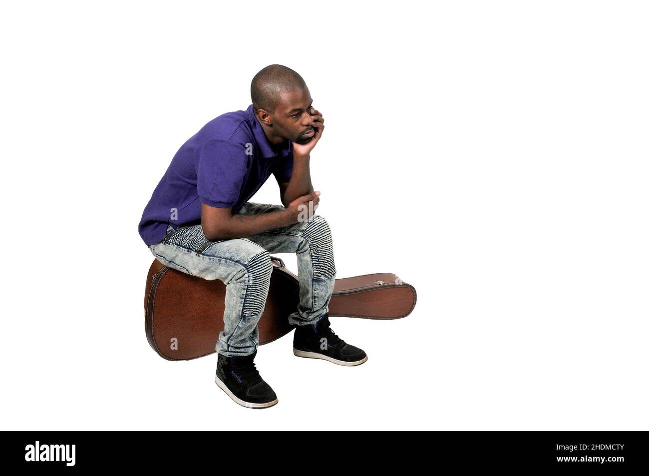 Handsome young black man with a acoustic guitar case Stock Photo
