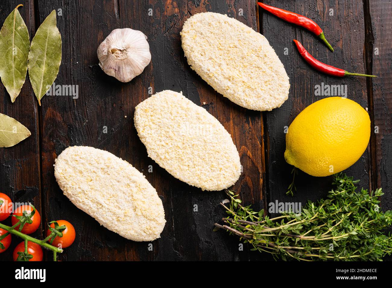 Fish cutlets from minced cod set, on old dark wooden table background, top view flat lay Stock Photo