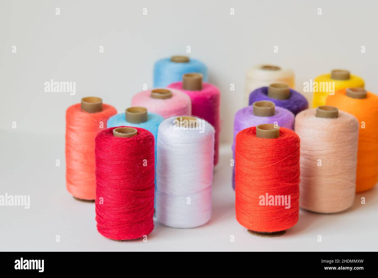 Colorful sewing thread rolls, spools on a white background Stock Photo ...