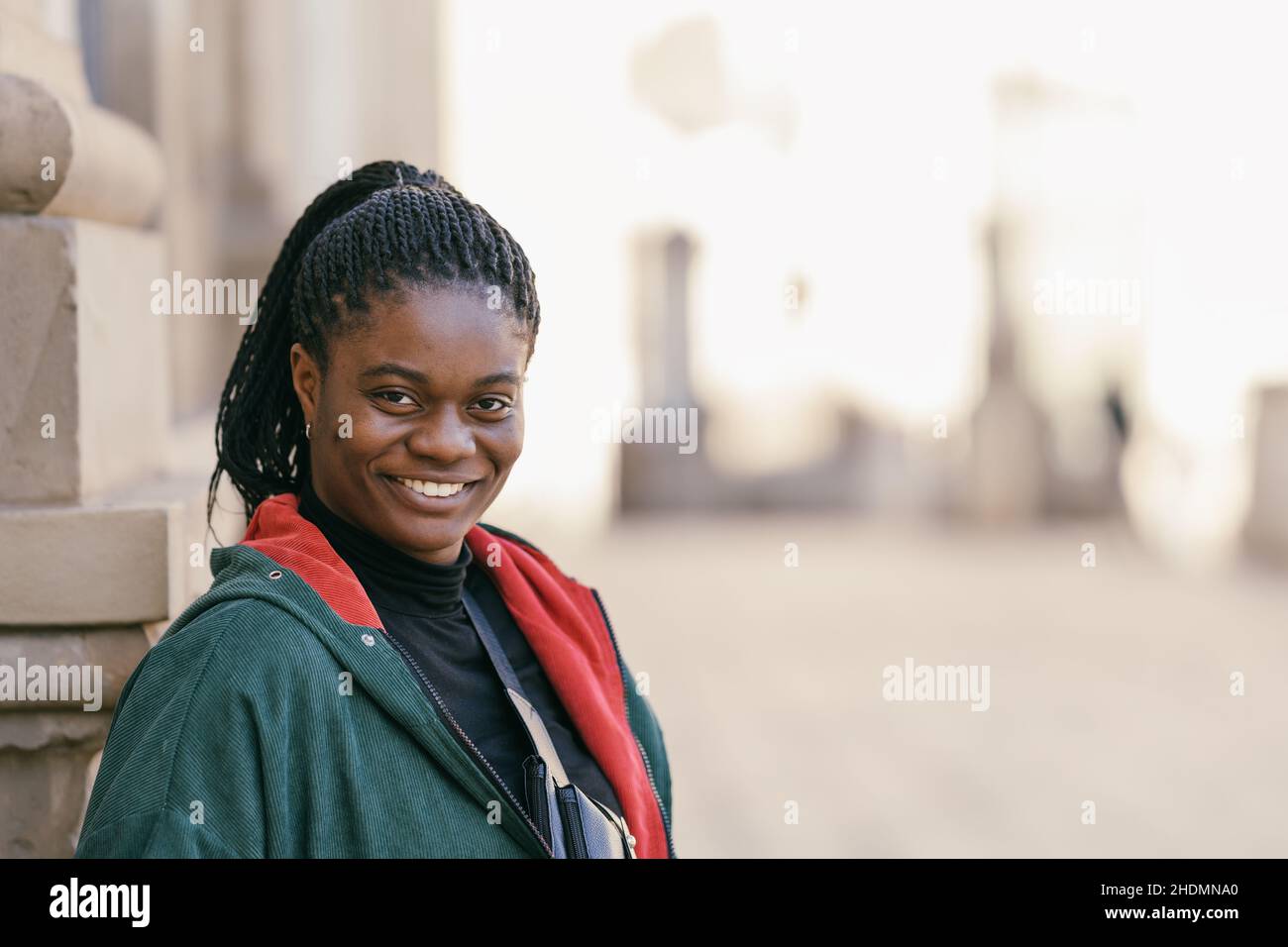 Portrait of a African woman smiling at the camera outdoors Stock Photo ...