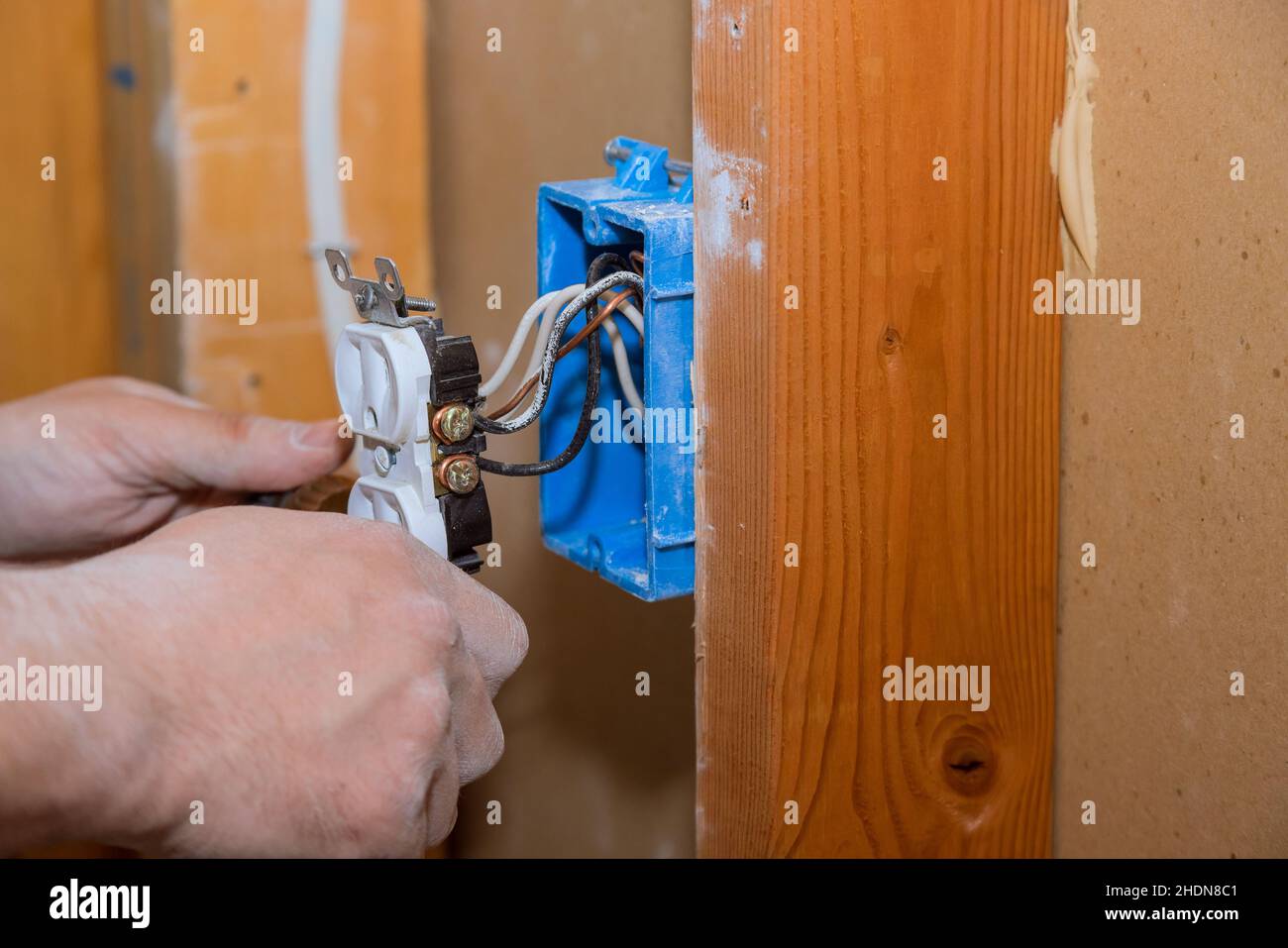 Preparing to remove an electrical outlet of the screws for electrical