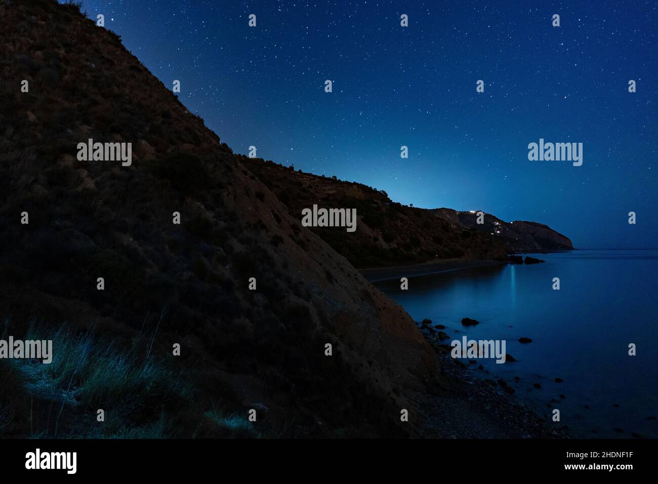 Beautiful rock formations by the sea at night Stock Photo - Alamy