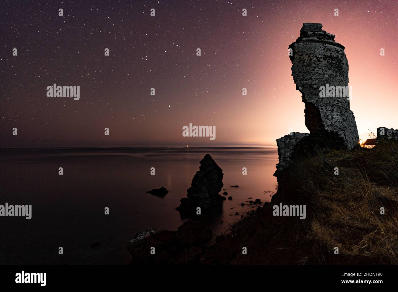 Beautiful rock formations by the sea at night Stock Photo - Alamy