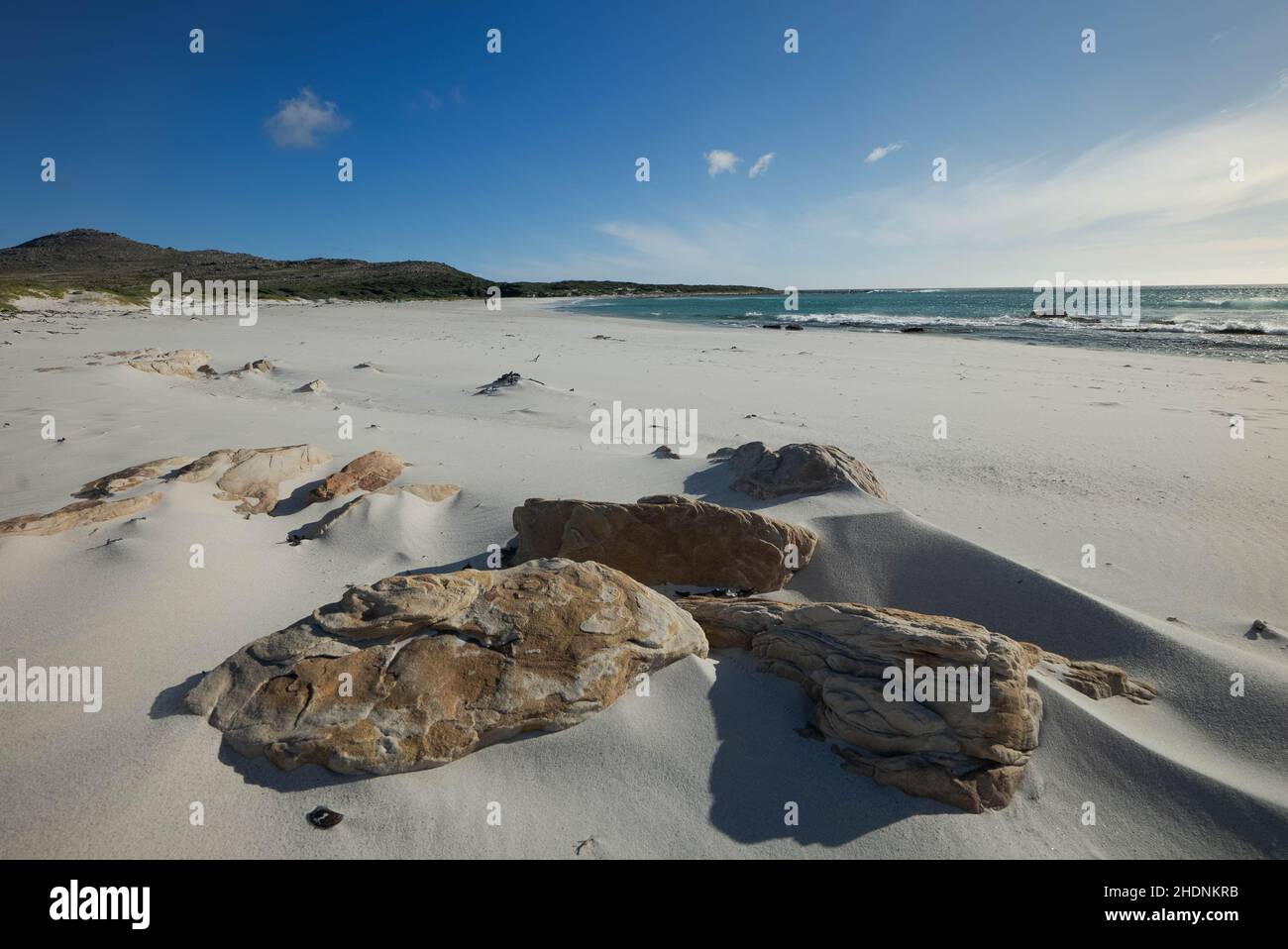 Beautiful view of the rocks on the sandy beach on the coast in Western Cape Stock Photo