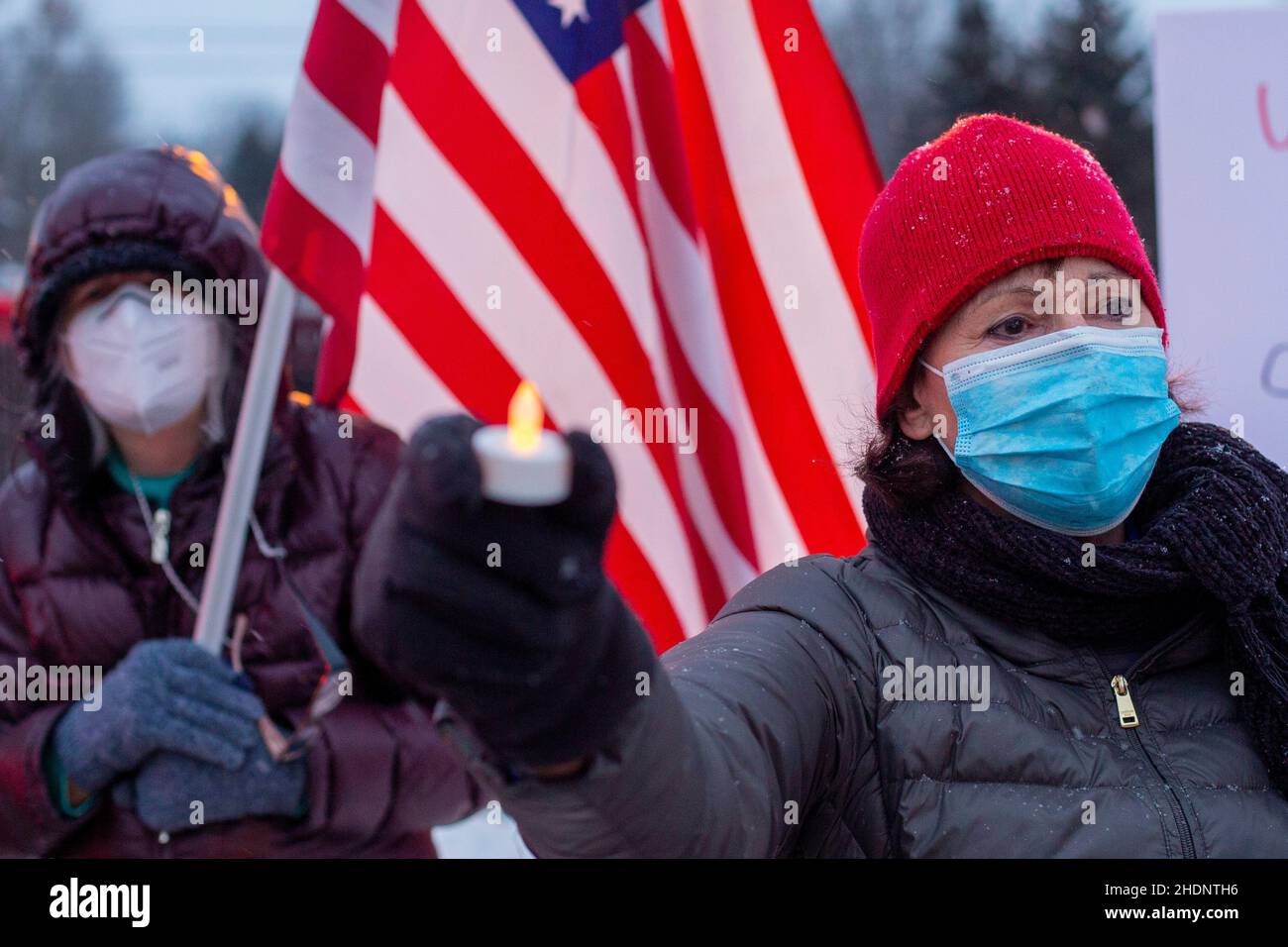 Rochester Hills, Michigan, USA. 6th Jan, 2022. A rally and vigil remembers and protests the violent attack on the U.S. Capitol a year earlier and opposes voting restrictions and efforts to sabotage free and fair elections. Similar vigils were held around the country. Credit: Jim West/Alamy Live News Stock Photo