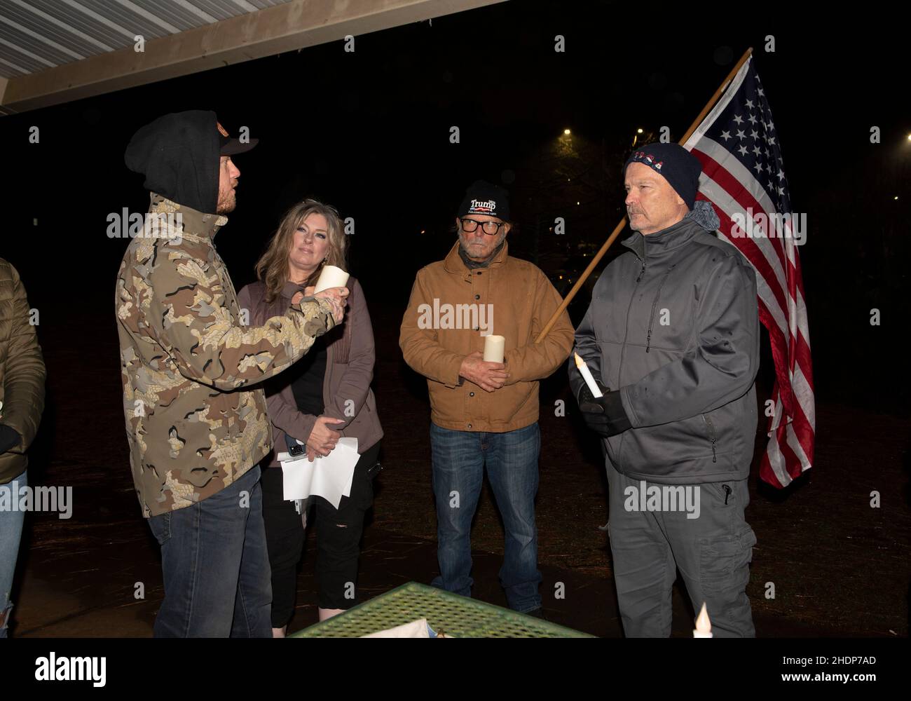 Woodstock, GA, USA. 6th Jan, 2022. Georgia Republican supporters of Former President Donald Trump gather at a Cherokee County park north of Atlanta for a prayer vigil to honor 'patriots' attending the January 6, 2021 protest at the U.S. Capitol. The vigil was organized by Look Ahead America group with candlelight vigils all across the country to honor the political prisoners and all those who've been politically persecuted in the aftermath of the January 6th protests, and to also commemorate the deaths of Ashli Babbitt and Rosanne Boyland.Pictured: RON LOEHRKE, 30. from Gainesville, Geo Credit Stock Photo