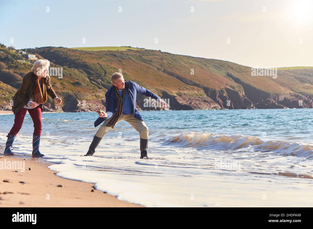 Woman throwing stone sea hi-res stock photography and images - Alamy