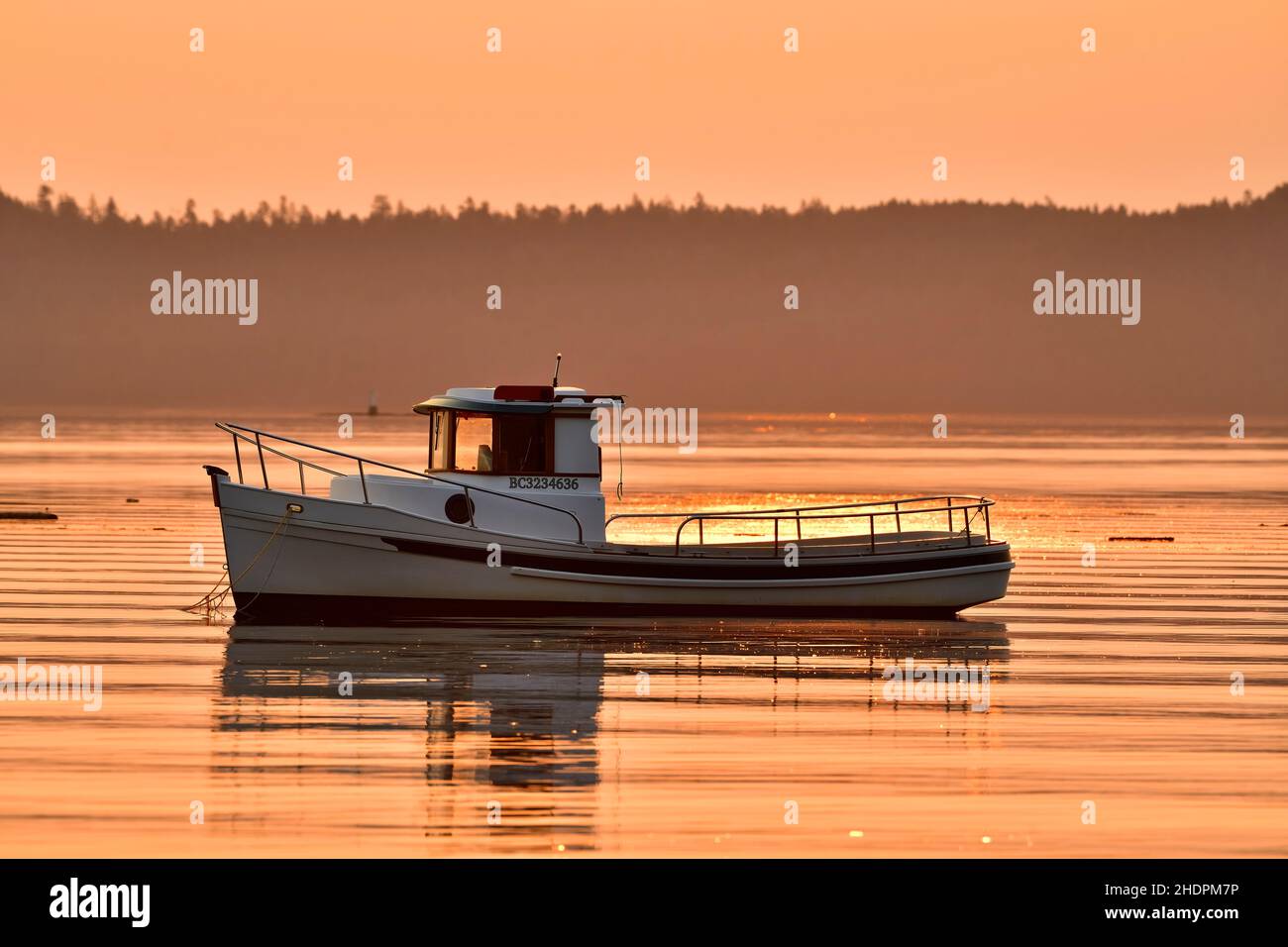 A smaller tug Boat in the early morning sunrise and moored in the harbor at near Ladysmith on Vancouver Island British Columbia Canada. Stock Photo