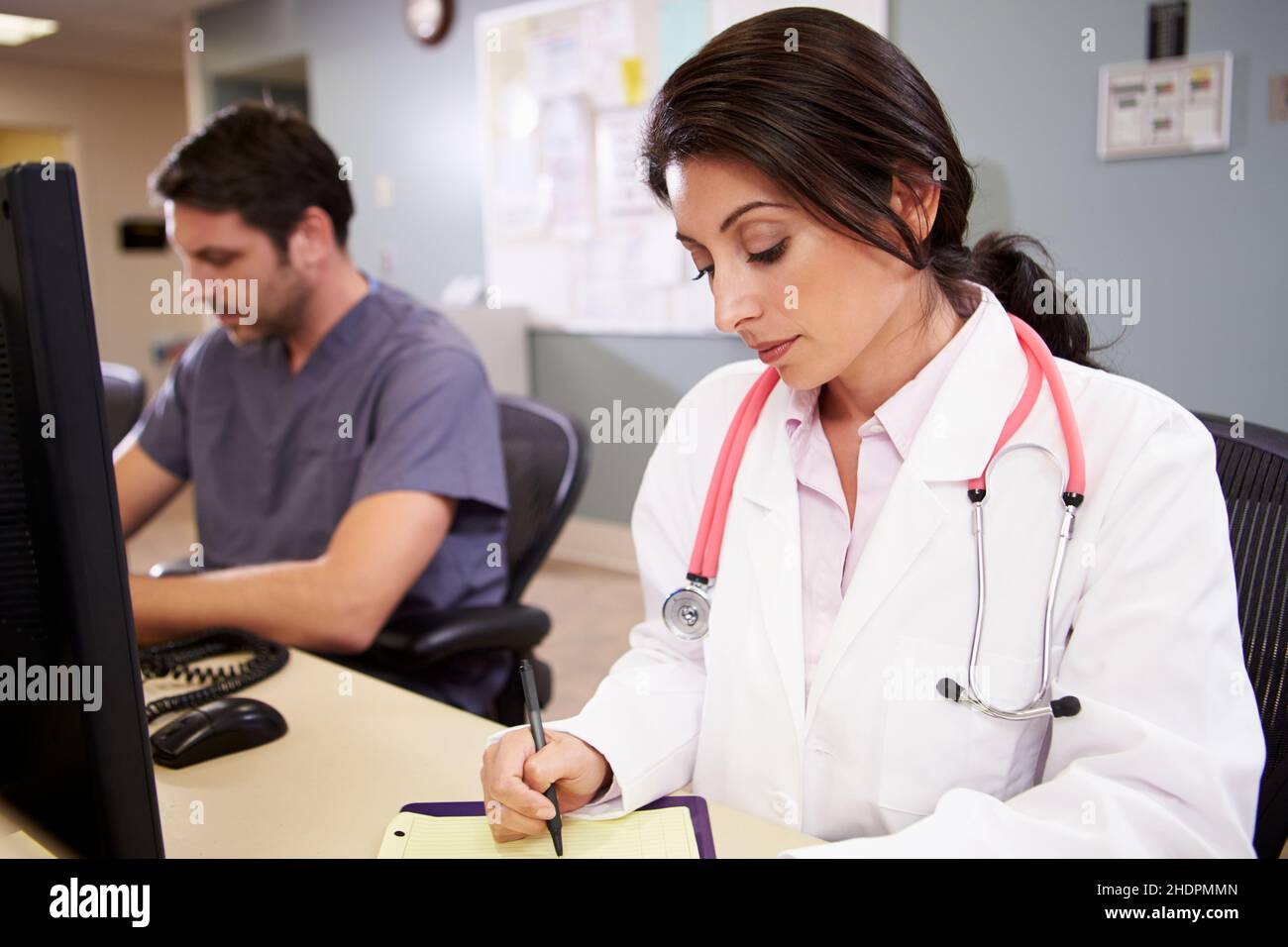 Female doctor writing hi-res stock photography and images - Alamy