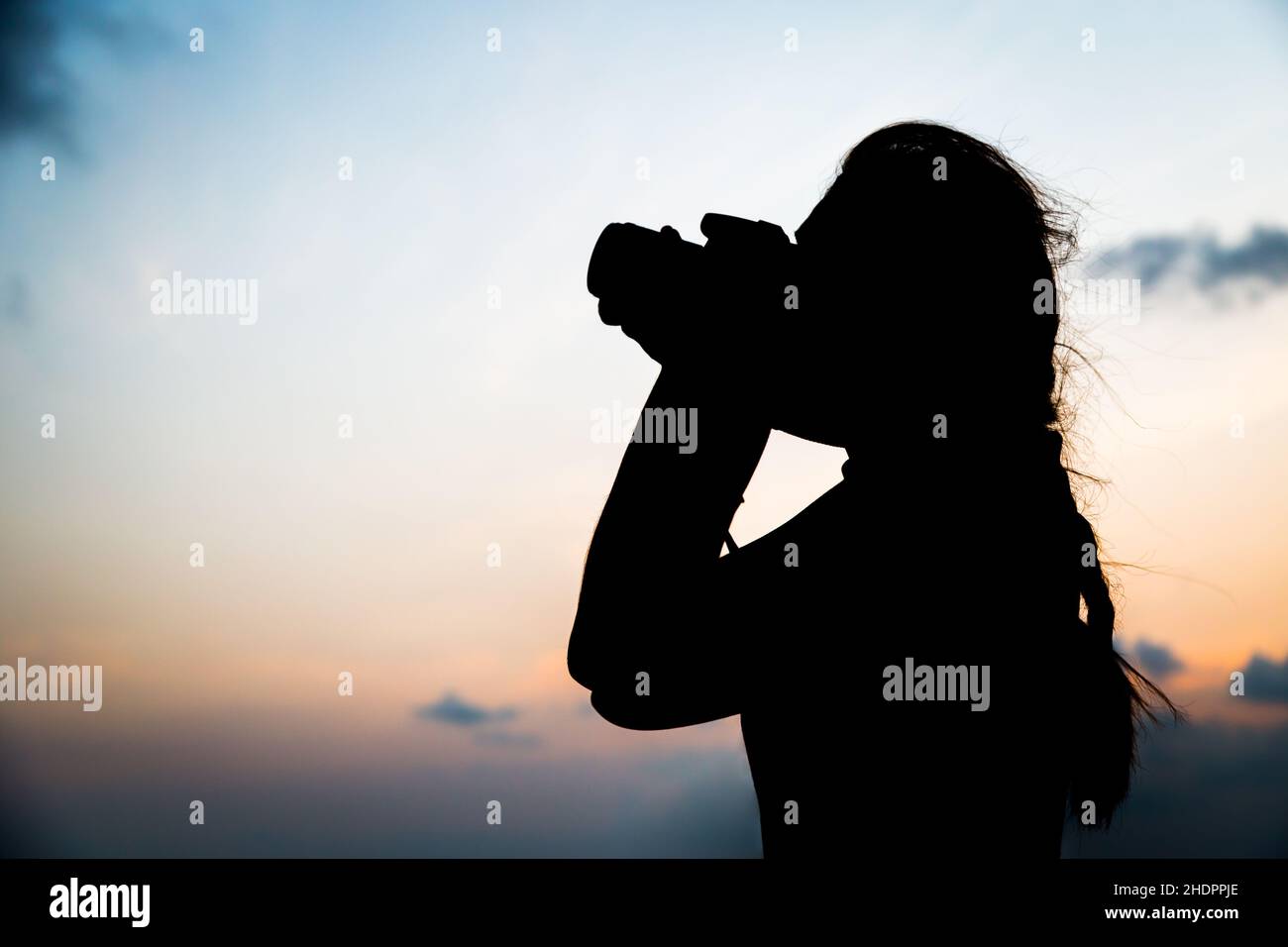 Silhouette photographer taking a picture on sunset background Stock ...