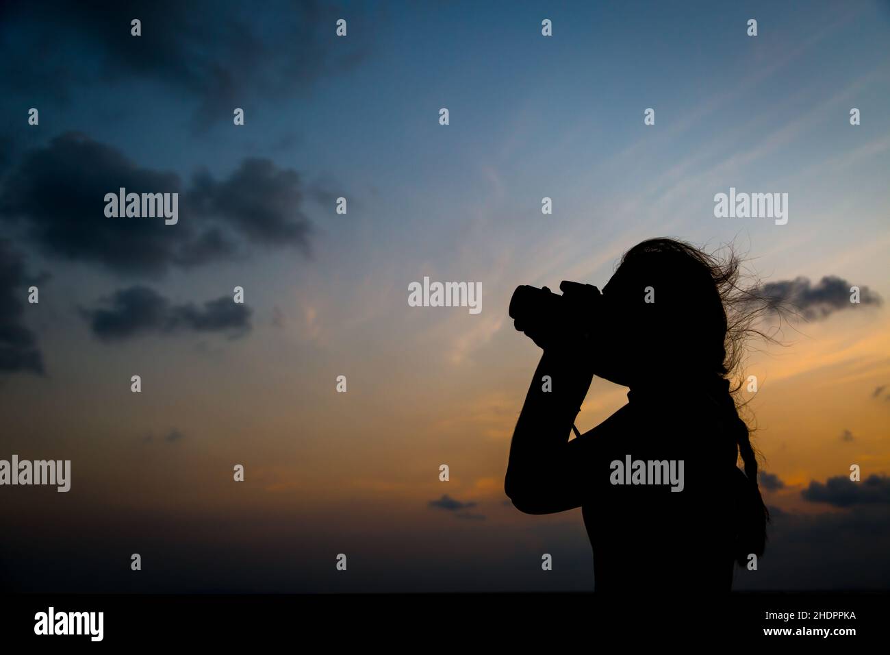 Silhouette photographer taking a picture on sunset background Stock ...