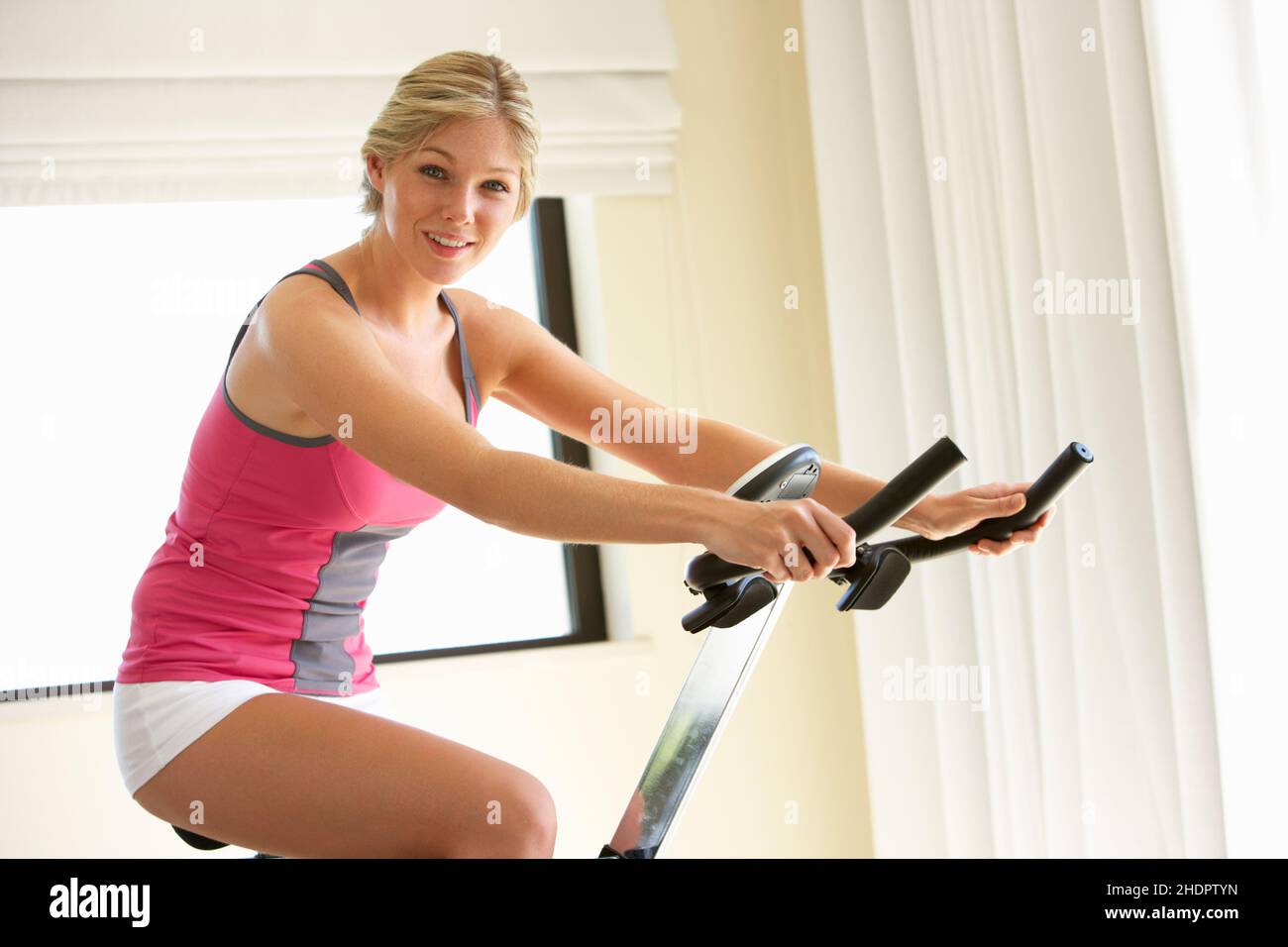 young woman, exercise bike, girl, girls, woman, young women, exercise bikes Stock Photo