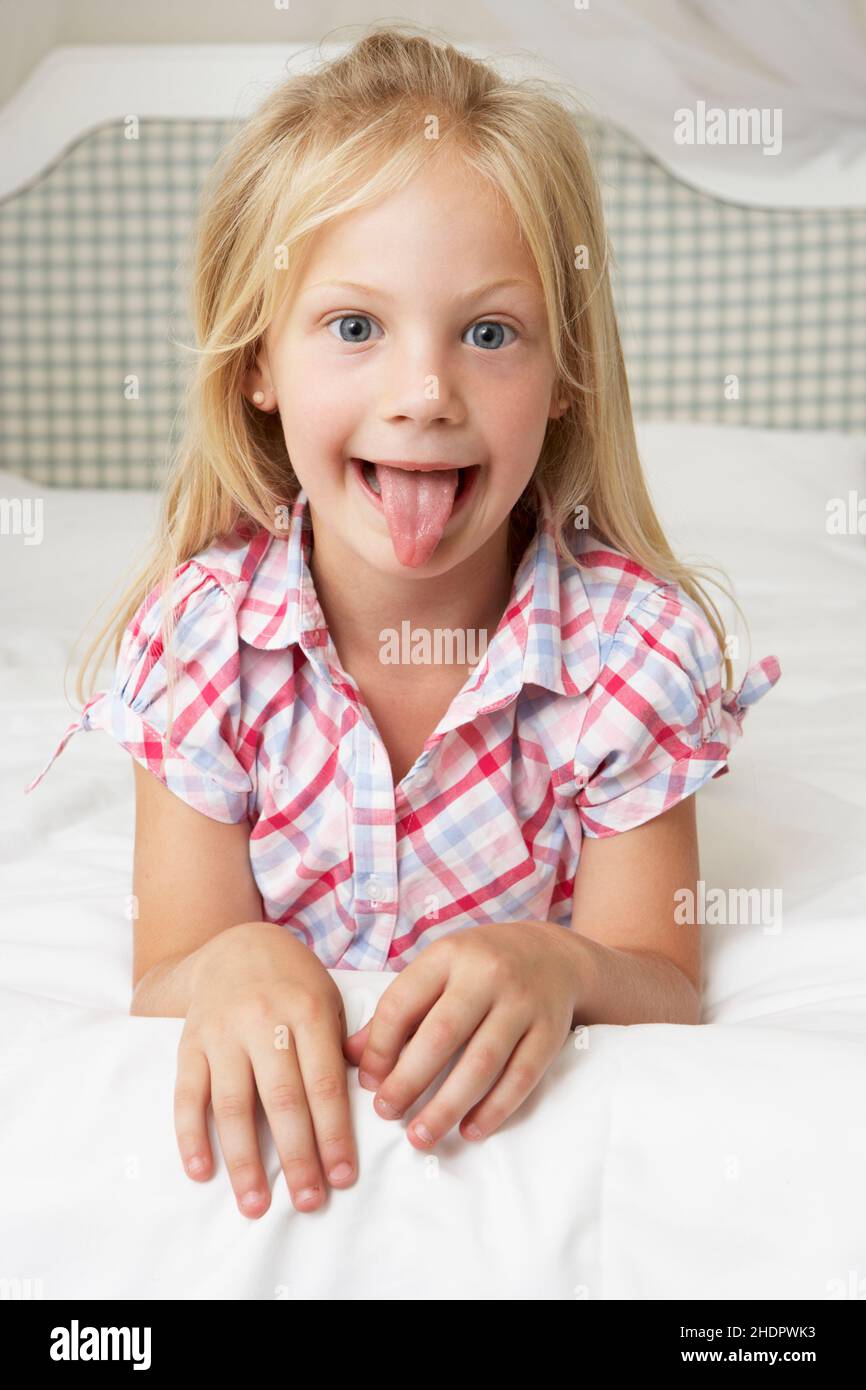 child, girl, naughty, sticking out tongue, children, childs, kid, kids, girls, barefaced, cheekily, cheeky, defiant, poking tongues, sticking out Stock Photo
