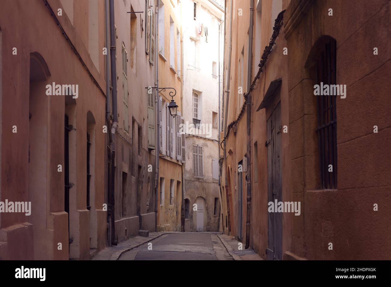 Narrow passage way between old crooked stone houses on a street of a French city Aix-en-Provence, Provence-Alpes-Côte d'Azur, Provence, South of Franc Stock Photo