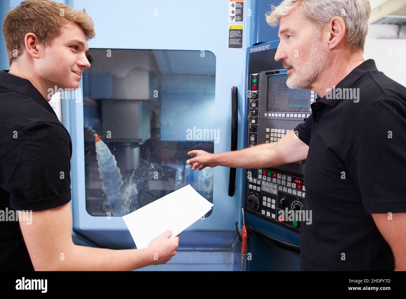 Manager supervising young trainee in hi-res stock photography and ...