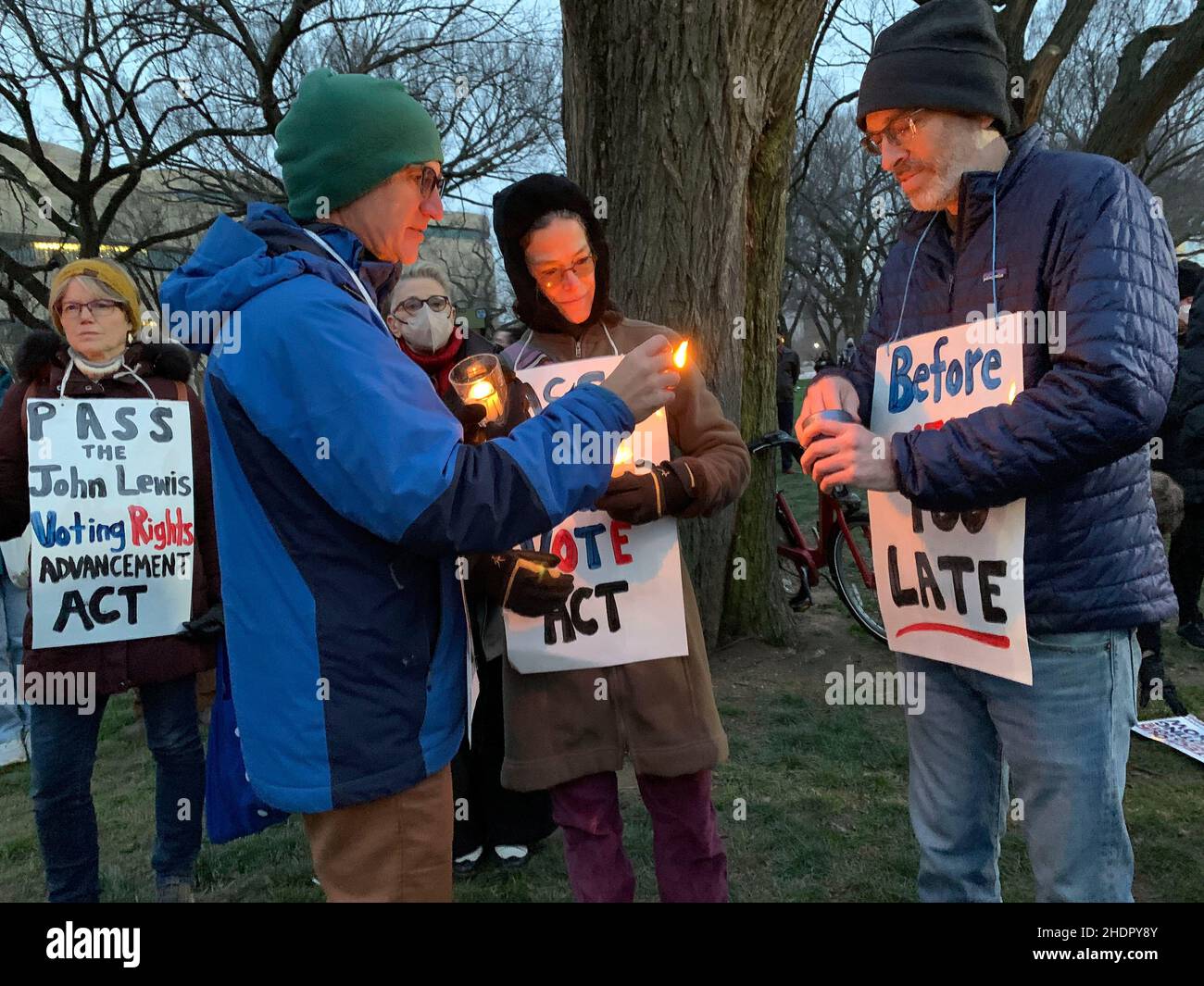 January 6, 2022, Washington, District of Columbia, USA: Robert Margolis lights a candle for Mark Dryer as Eliza Savage looks on during the Candlelight Vigil for Democracy held on the anniversary of the January 6 attack on the U.S. Capitol and the attempted disruption of the electoral vote count that would certify President-elect Joe Biden. (Credit Image: © Sue Dorfman/ZUMA Press Wire) Credit: ZUMA Press, Inc./Alamy Live News Stock Photo