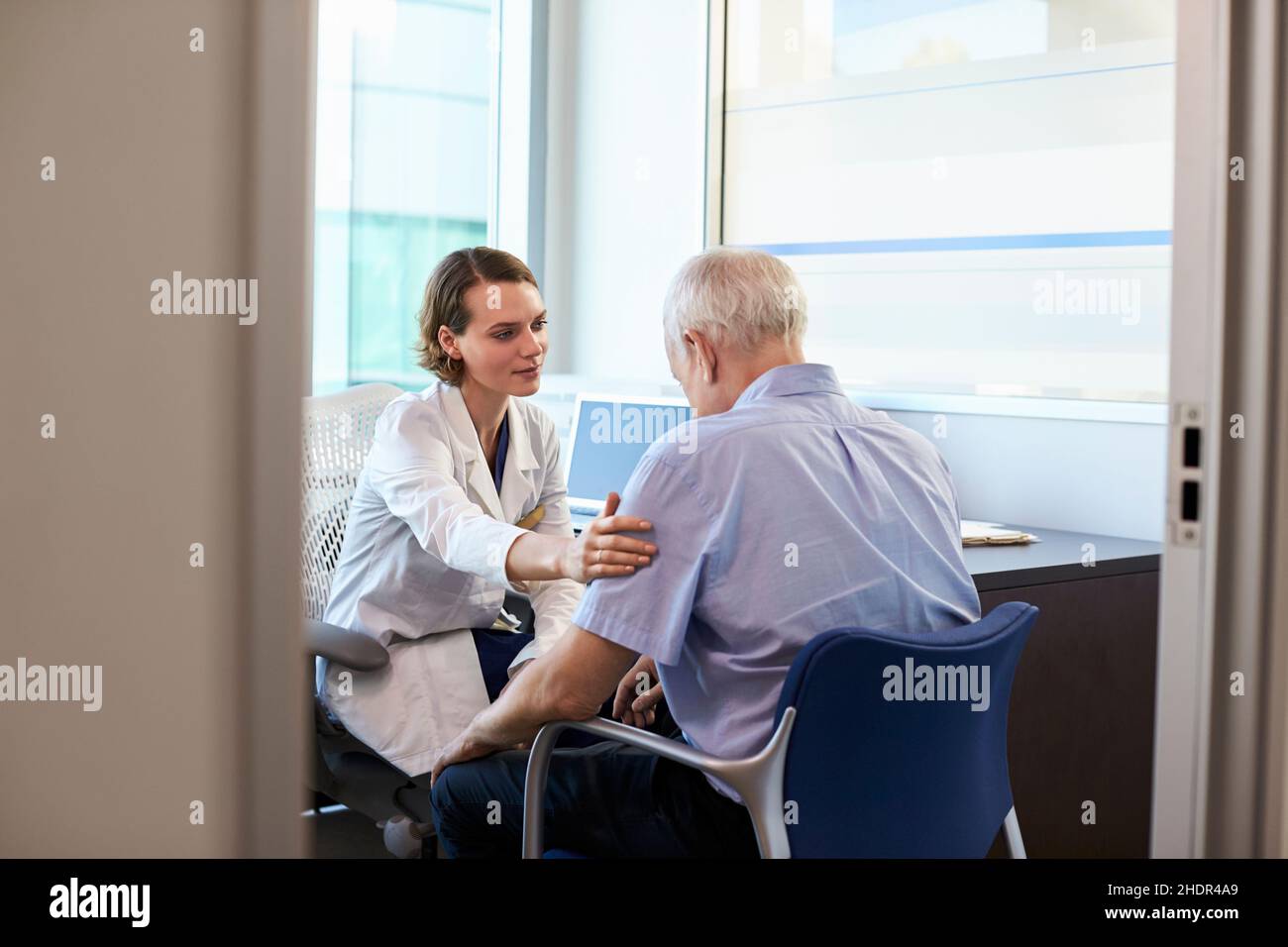 Doctor consoling female patient hi-res stock photography and images - Alamy