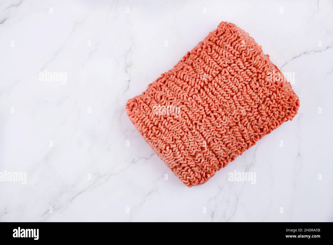 Fresh raw ground beef isolated on white background. Top view. Stock Photo