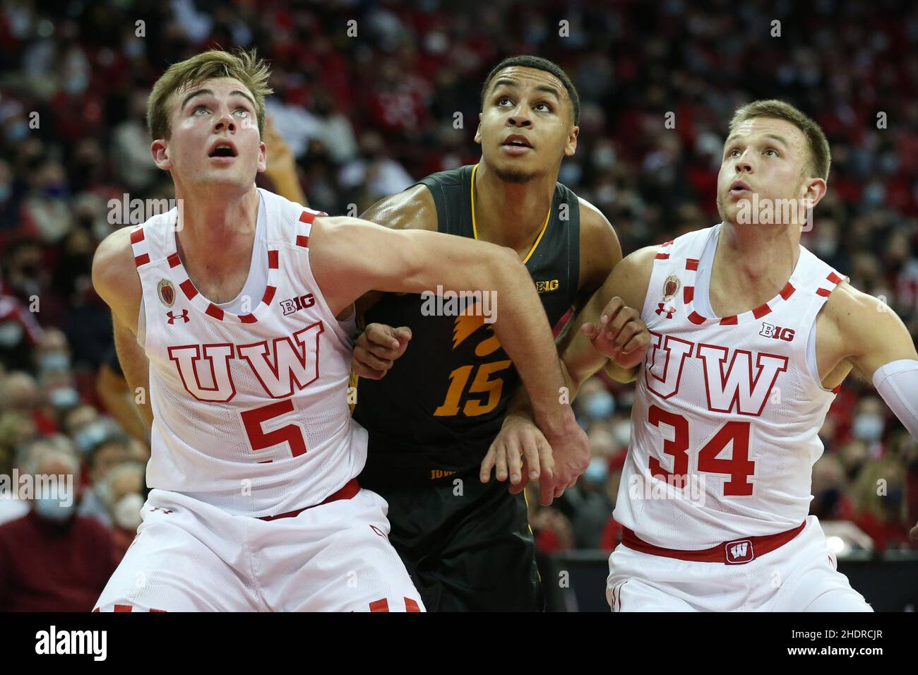 Madison, WI, USA. 06th Jan, 2022. Wisconsin Badgers forward Tyler Wahl (5) and guard Brad Davison (34) block out Iowa Hawkeyes forward Keegan Murray (15) during the NCAA Basketball game between the Iowa Hawkeyes and the Wisconsin Badgers at the Kohl Center in Madison, WI. Darren Lee/CSM/Alamy Live News Stock Photo
