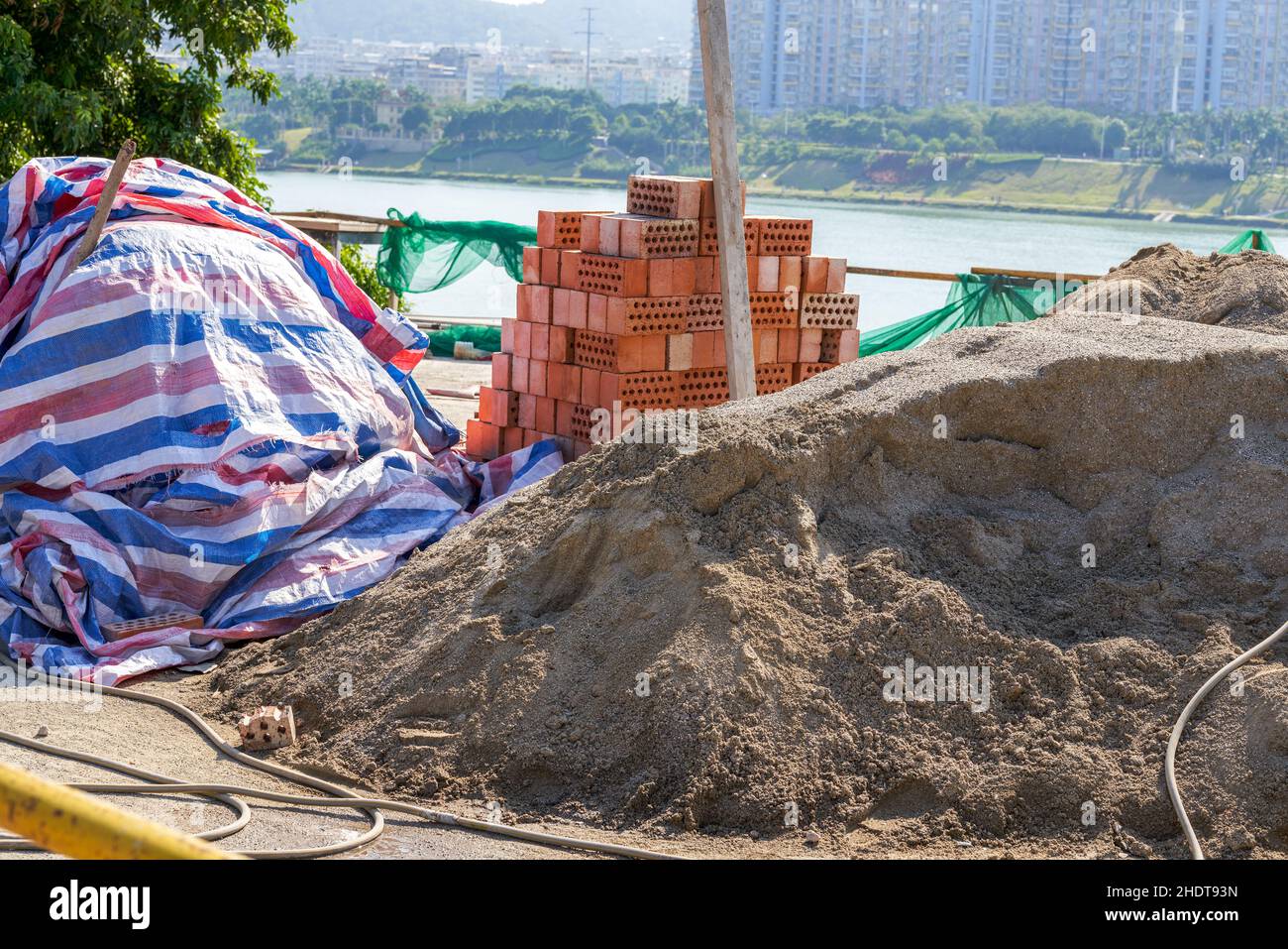 Pile of cement and bricks at roadside construction site Stock Photo - Alamy