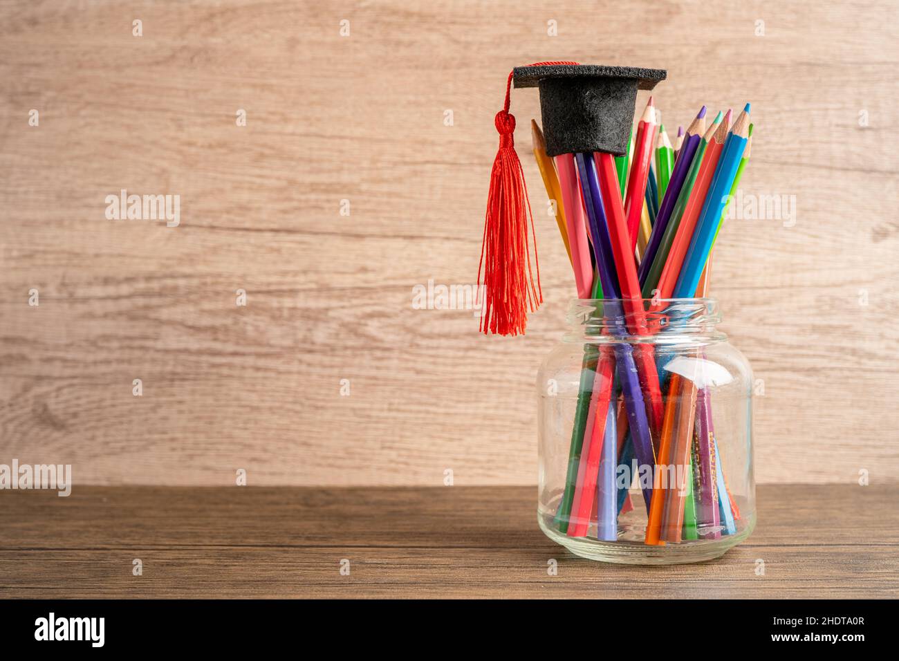 Graduation hat with colorful pencils with copy space, learning