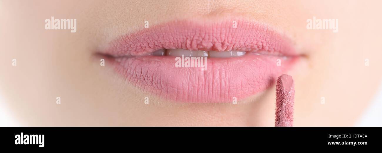 Painted female lips with lipstick brush closeup Stock Photo Alamy