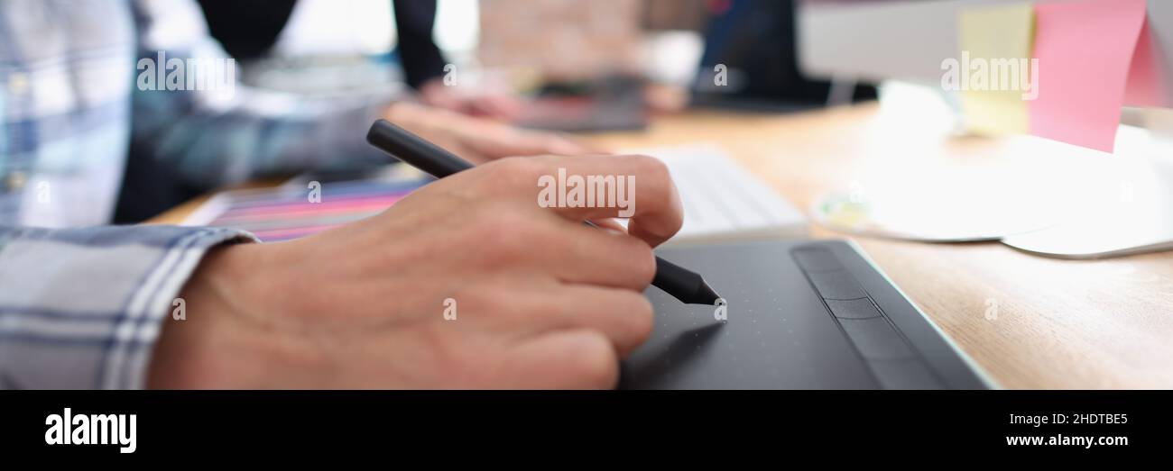 Two graphic designers working in office closeup Stock Photo