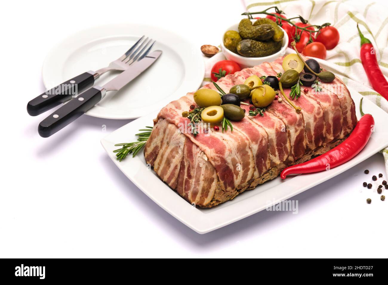 Traditional French terrine covered with bacon isolated on white