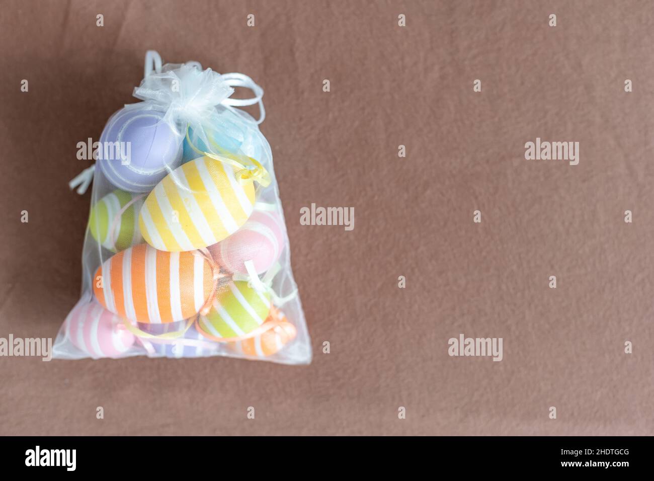 multi-colored chicken eggs in bag mesh on background. easter Stock Photo