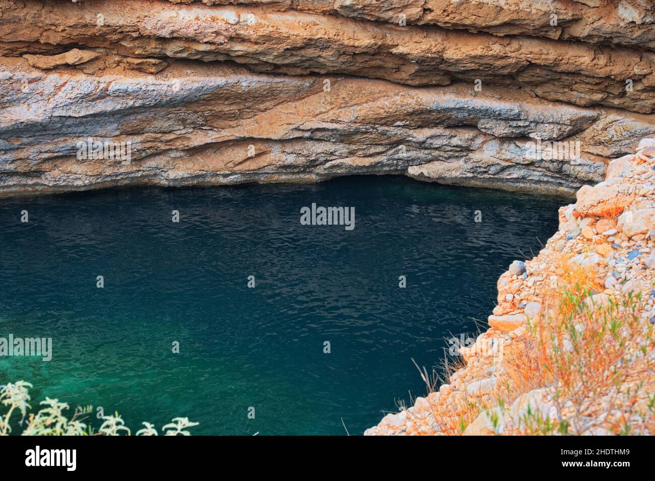 Clear turquoise water in Bimmah sinkhole in Oman Stock Photo