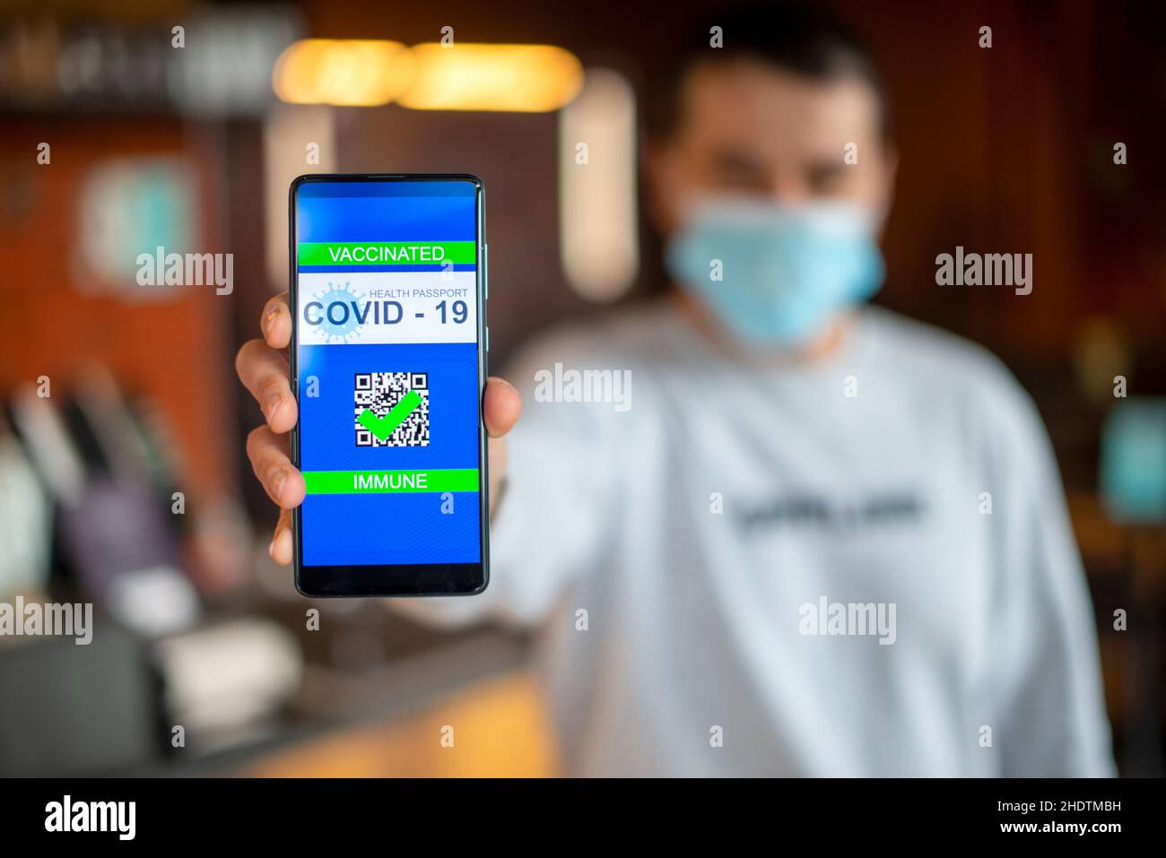 Covid-19 Health Passport. man holding cell phone with qr code covid 19 ...