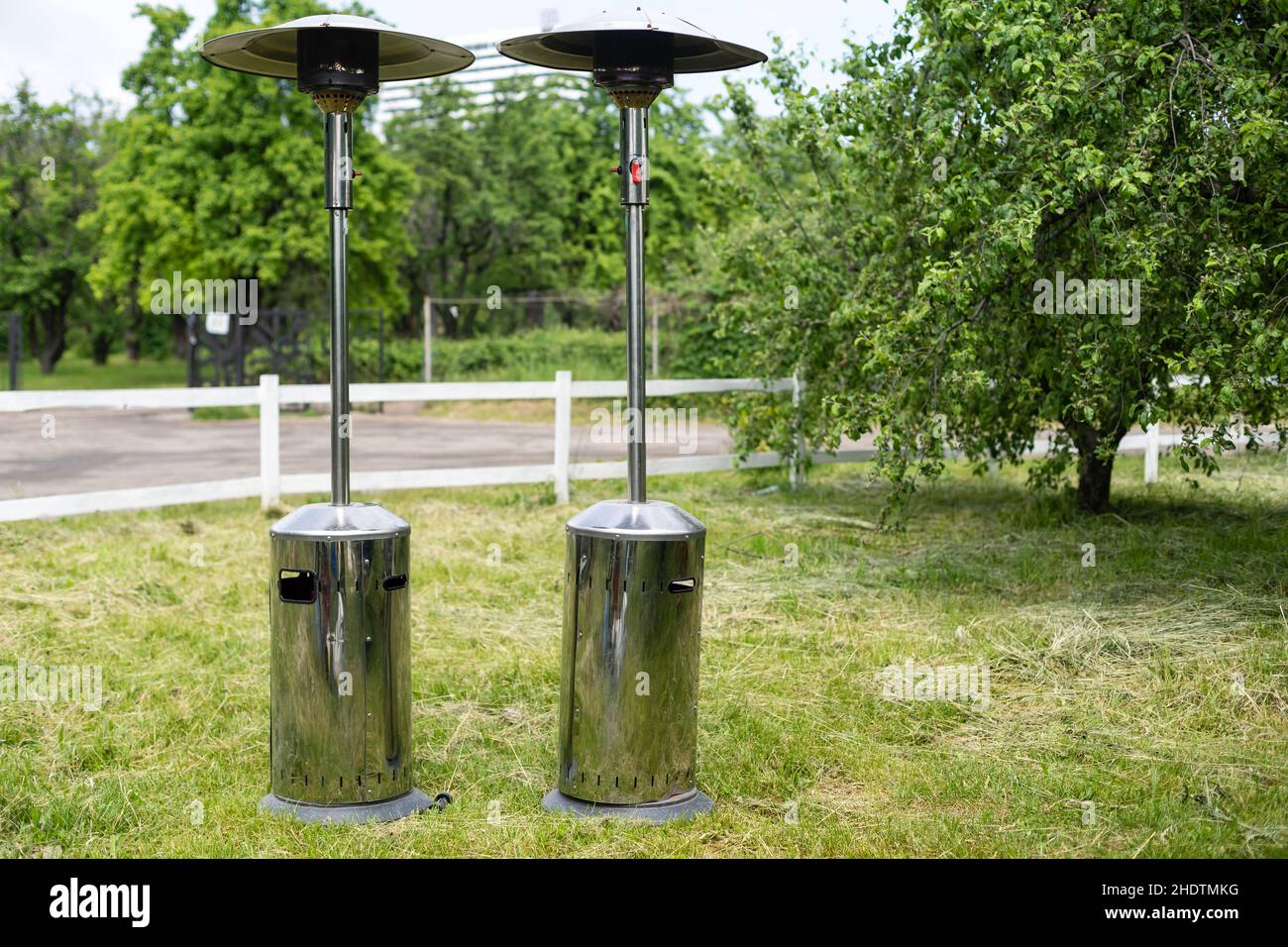 Gas outdoor heater working on terrace. Steel metal warming device. Stock Photo