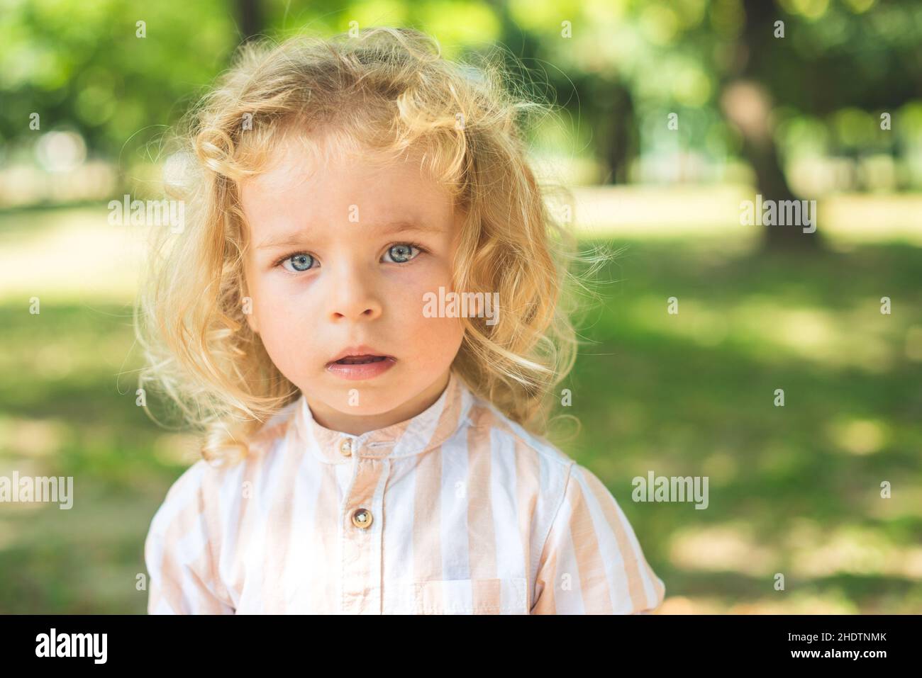 Handsome boy with blue eyes and curly blond hair Stock Photo