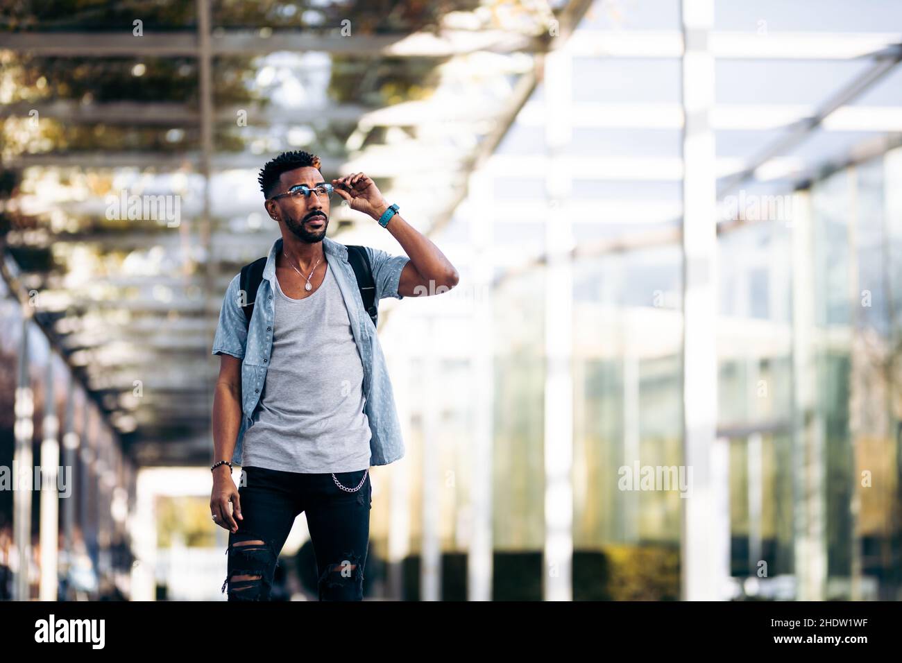 Young black african man walking hi-res stock photography and images - Alamy