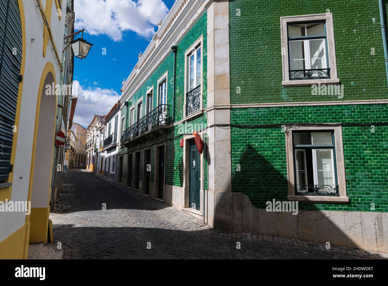 House with green ceramic tiles (azulejo's) in a narrow cobbled street in Beja, Alentejo, Portugal Stock Photo