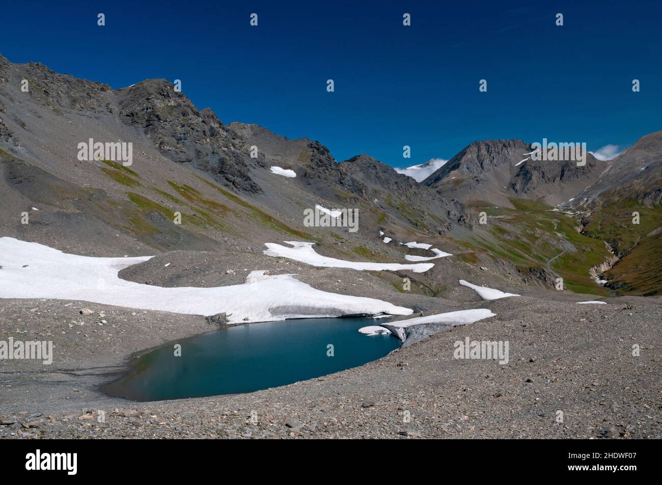 The lake of the ancient La Jave glacier with Signal de l’Iseran summit (3237m) and Pers mountain pass in the background, Vanoise massif, Haute-Maurien Stock Photo