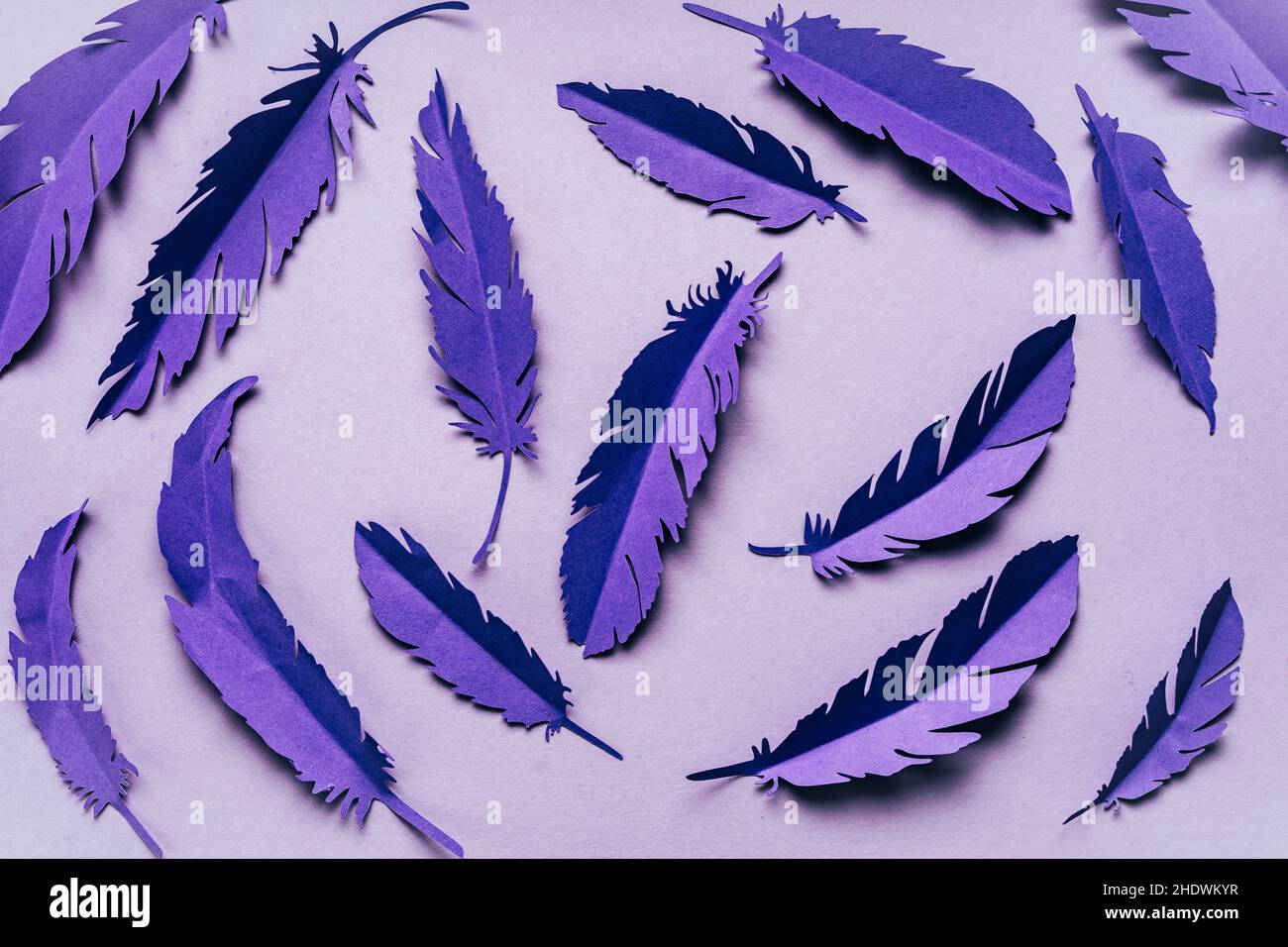 Abstract violet very peri background with paper feathers Stock Photo