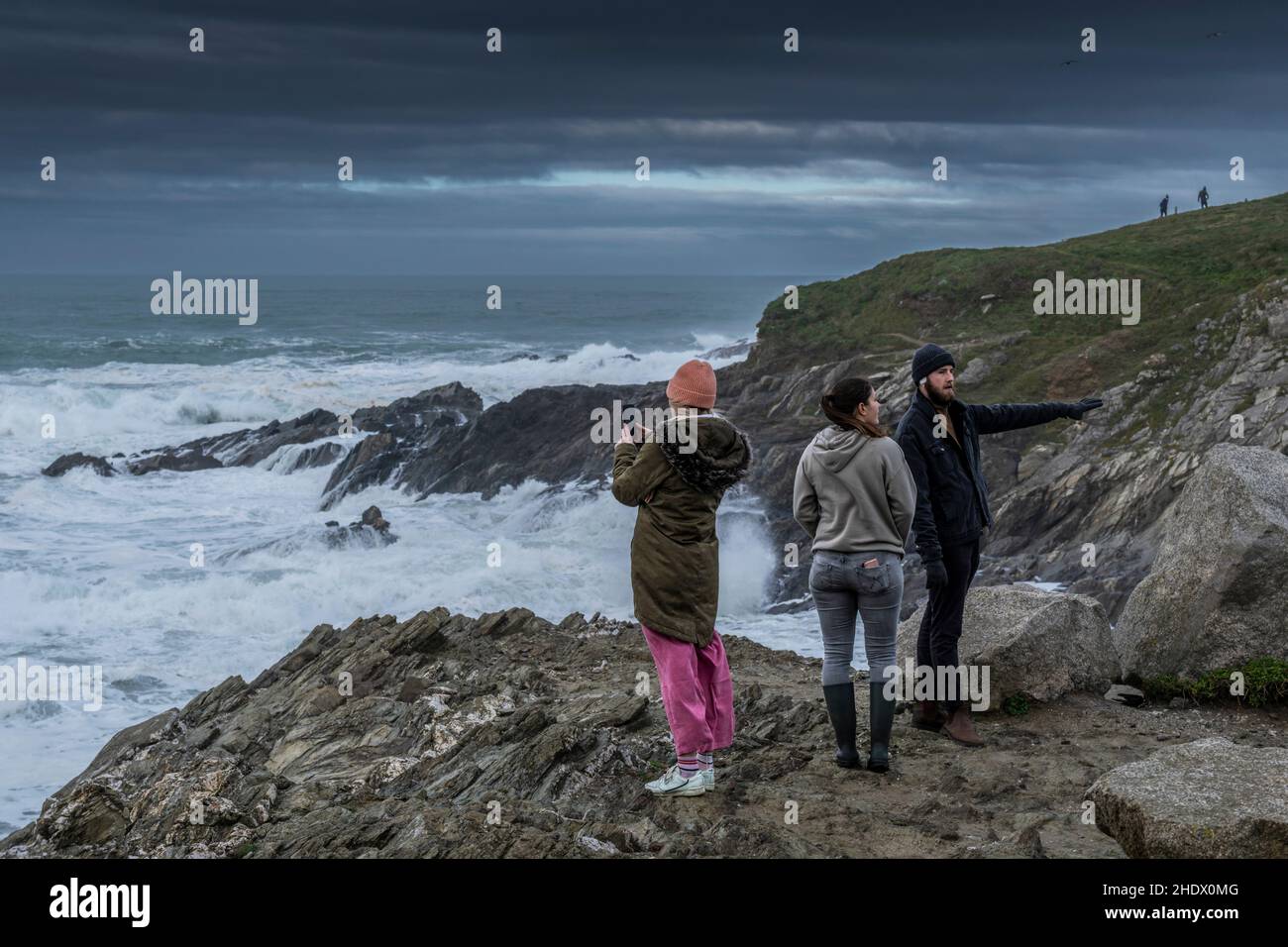 People visiting Towan Head in Newquay during windy weather conditions over the North Cornwall coast in the UK. Stock Photo